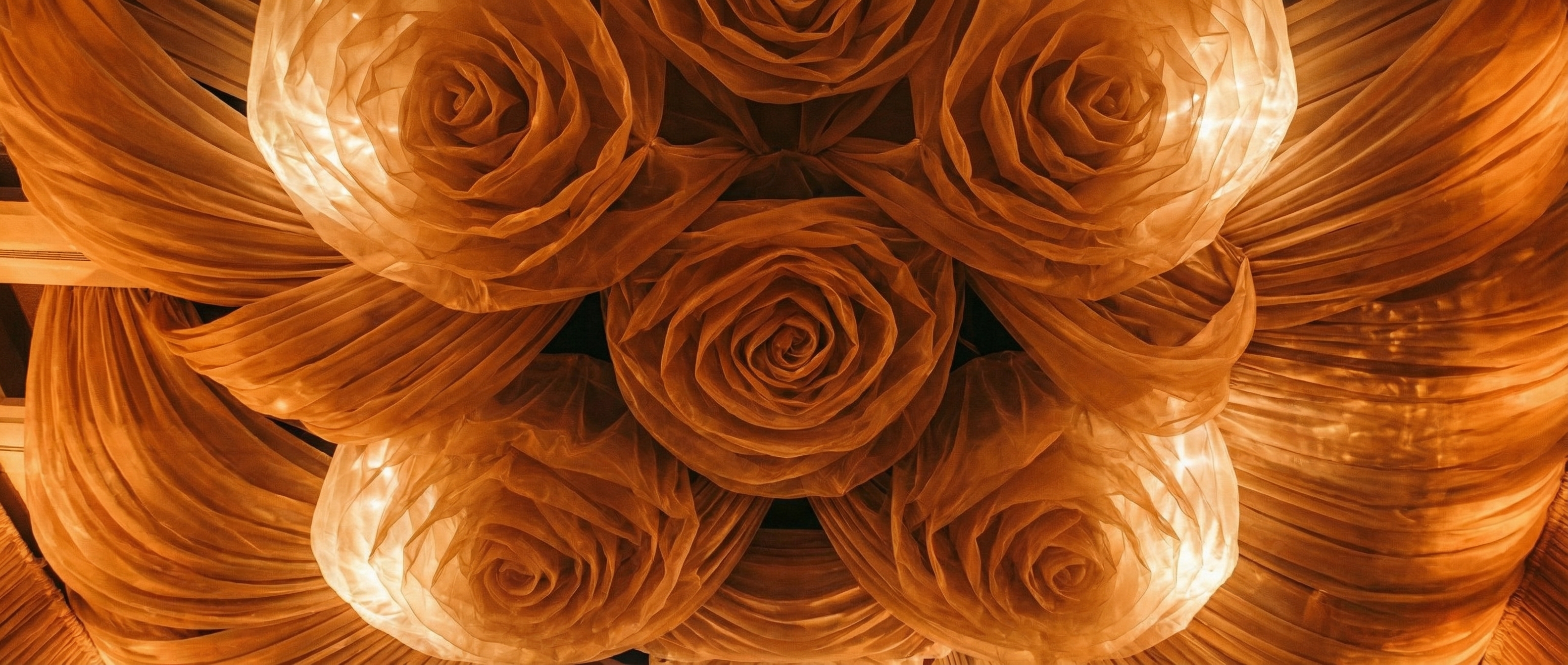 Champagne silk ceiling swags transforming a gala ballroom